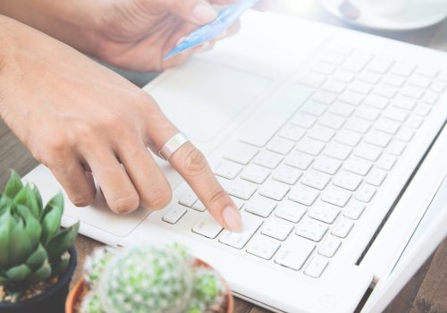 woman hand using laptop computer holding credit card online shopping scaled.jpg